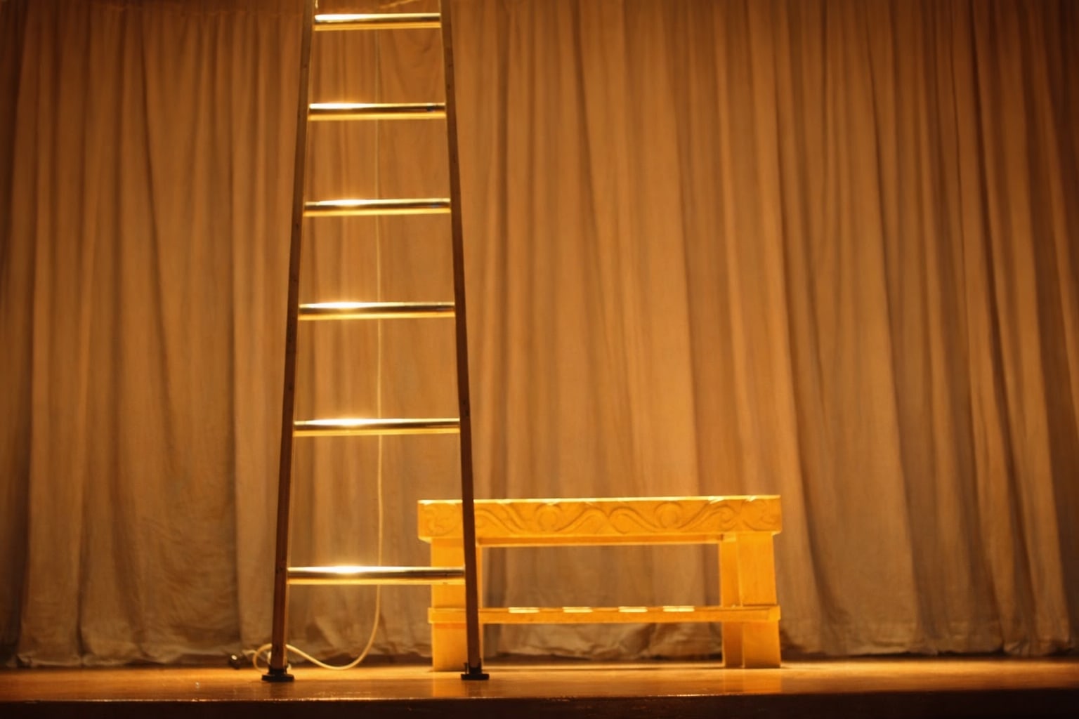 The Living Canon — a theatre auditorium hung with filament lights, the house waiting.
